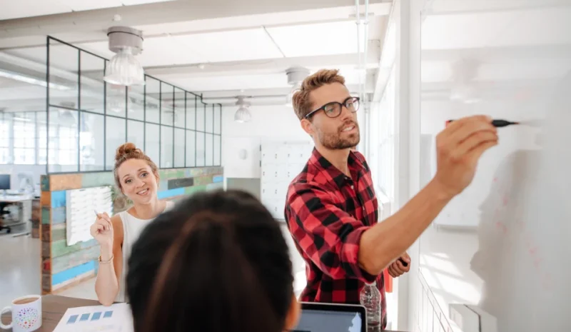 casual_young_businessman_giving_presentation_to_co_2024_09_13_05_31_15_utc_1