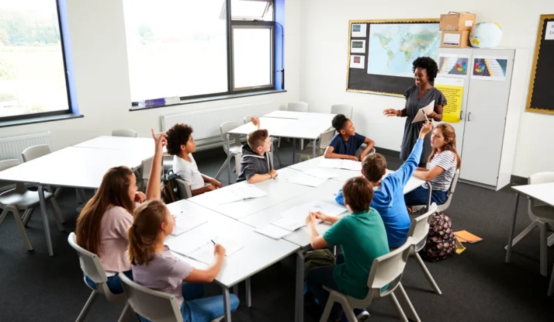 high_school_students_raising_hands_to_answer_quest_2024_10_20_04_46_15_utc_1